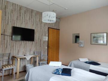 Фото номера Трехместный номер эконом-класса с общей ванной комнатой Отель Hotel Vuolake г. Лаукаа 7